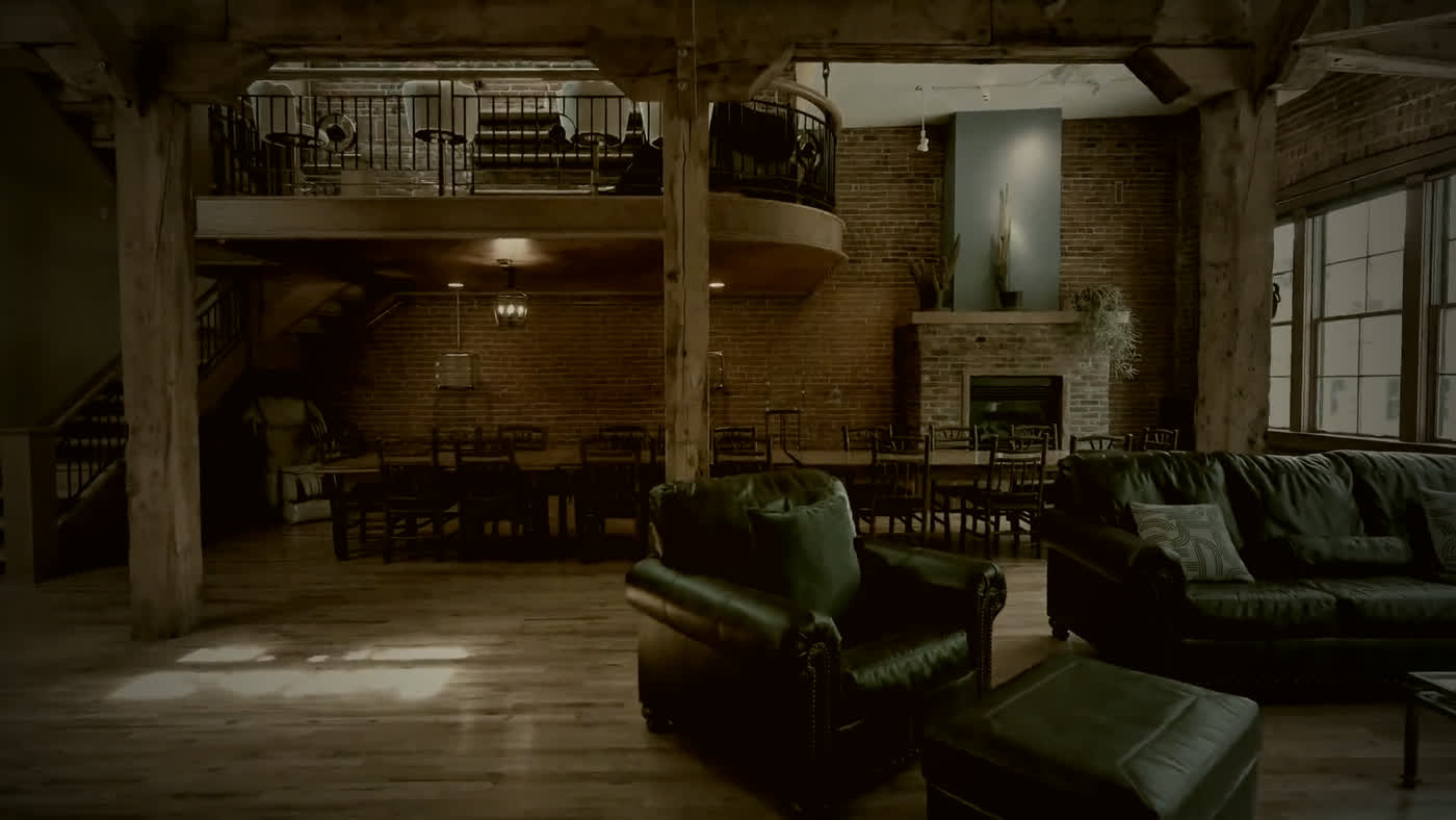 The great room at The Reserve, timber beams, brick and the mezzanine